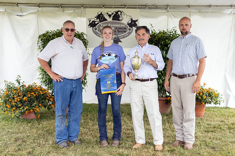 The F. Ambrose Clark Livestock Cup Winner: Mikaylee Woodin of Walton, NY showing her Market Hog “Grunkle.” Also pictured: Clyde Cranwell and Ben Williamson, Livestock Judges, and Paul D’Ambrosio, President & CEO of The Farmers’ Museum.